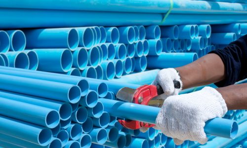 worker cut pvc pipe in construction site